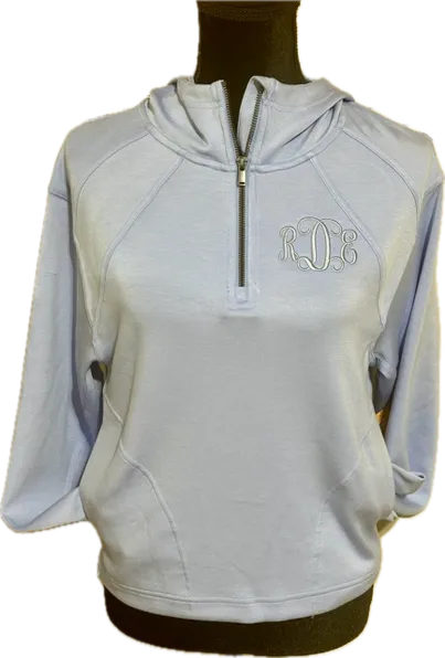 Light blue quarter-zip hoodie with embroidered script monogram